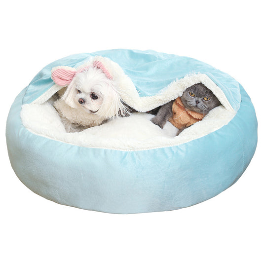 CozyCalm round hooded dog bed in light blue with a small white dog and a cat under the hood