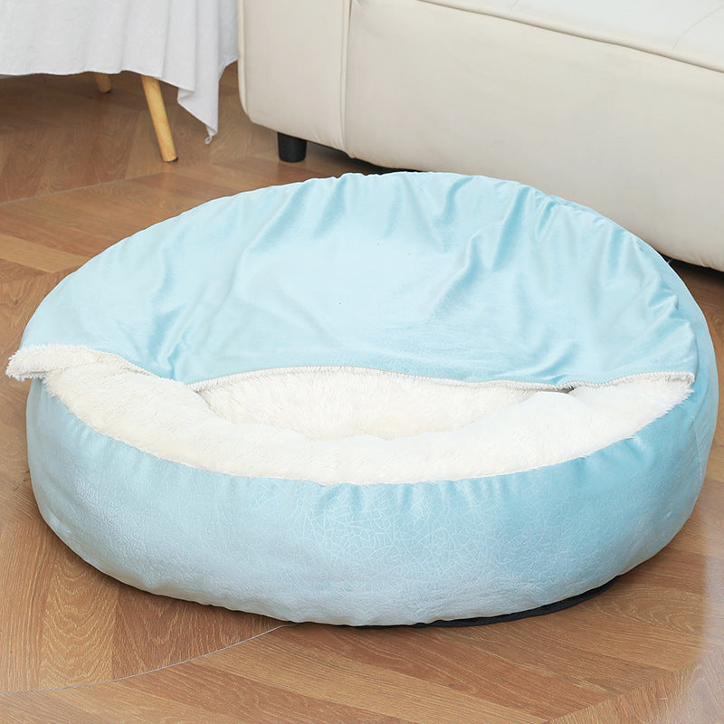 Light blue round hooded dog bed with plush lining, empty