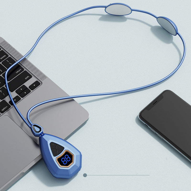 Blue EMS neck massager on a desk next to a laptop and smartphone