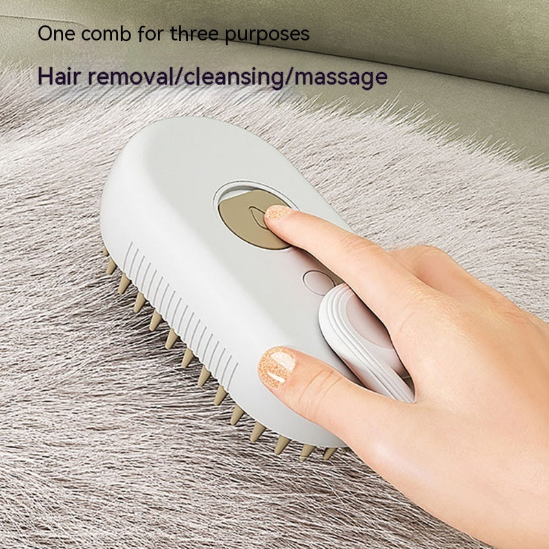White SteamyGroom 3-in-1 pet steam brush pressed by a finger on soft gray fur